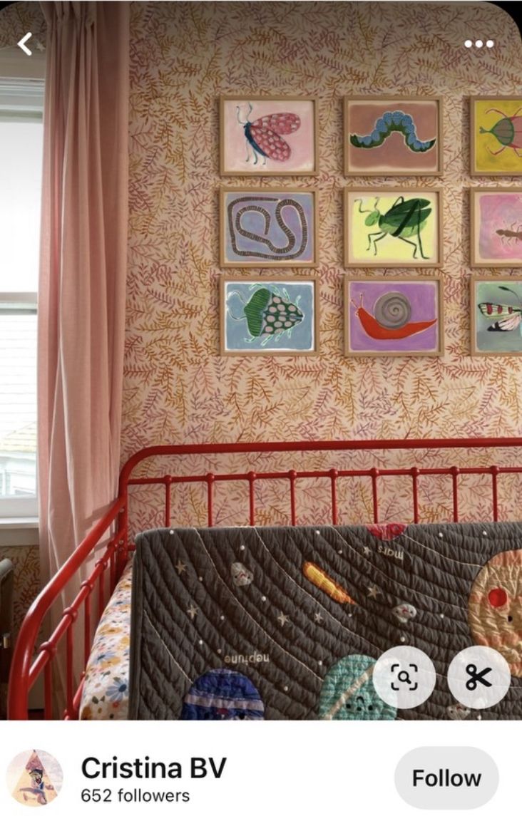 an image of a child's room with pictures on the wall and in the crib