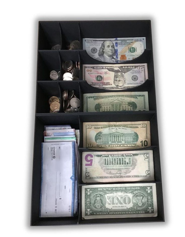 a drawer filled with money and other items