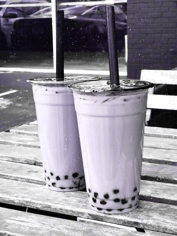 two drinks sitting on top of a wooden table