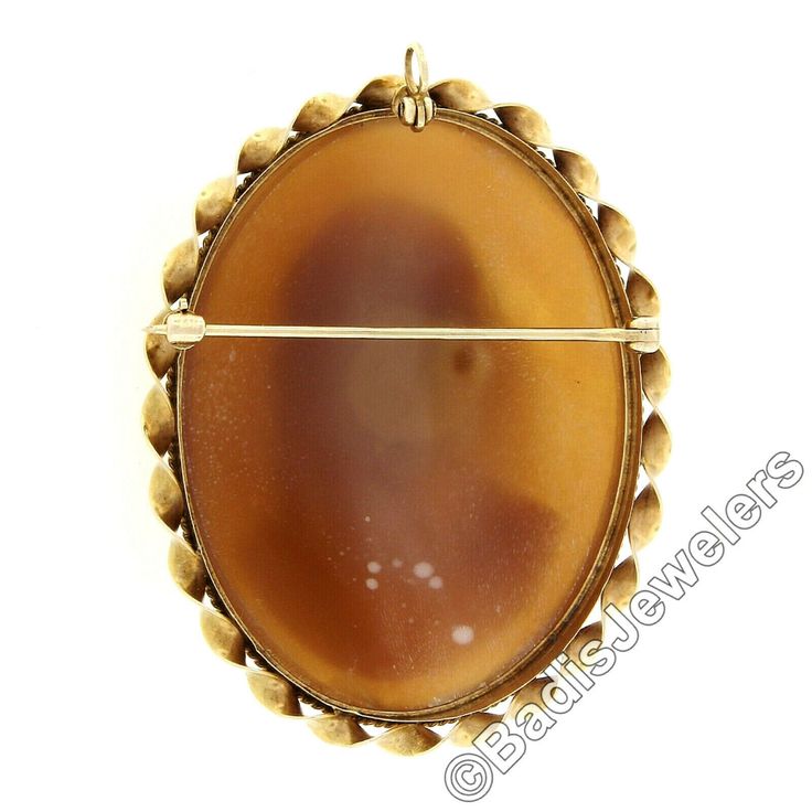 "This unique vintage brooch or pendant was crafted from solid 14k yellow gold. It features a large oval shaped carved shell cameo bezel set at its center. The piece of shell used for this particular carving is very uniquely convex shaped allowing the portrait to have a domed 3D look. That cameo is then surrounded by a pair of twisted wire frames with a finer one on the inside and a much coarser one on the outside.This unique vintage piece remains in excellent and 100% ready to wear upon arrival. Antique Oval Carved Brooches, Oval Cabochon Brooches For Anniversary, Antique Oval Cabochon Brooches, Yellow Gold Oval Cameo Brooch, Gold Oval Carved Brooches, Oval Carved Gold Brooches, Vintage Yellow Gold Oval Brooch, Classic Oval Cabochon Brooches, Classic Oval Brooches For Collectors