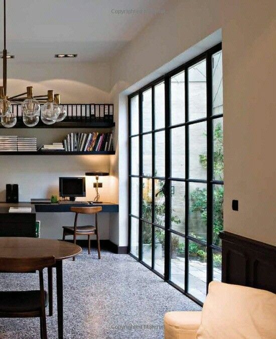 a living room filled with furniture and a book shelf on top of a wooden table