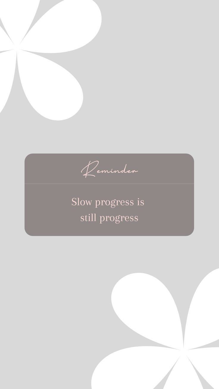 a white flower on a gray background with the words slow progress is still progress written in pink