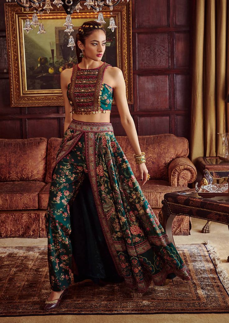 Editor's Note Featuring a classically feminine silhouette, hand painted and printed with floral motifs in vibrant colours. It is intricately adorned with embroidery and coin-work. The skirt is a combination of palazzo pants and wrap around skirt. Fabric: Blouse & lehenga: viscose silk Color: Green Components: Blouse and lehenga Occasion: Wedding Guest and festive Disclaimer: Product color may slightly vary due to photographic lighting sources or your monitor setting. Care: Dry Clean Only About t Indian Skirt Designs, Western Lehenga Designs Latest, Skirt Blouse Designs Latest, Palazzo Lehenga, Indowestern Outfits, Delhi Fashion, Skirt Indian, Lehenga And Blouse, Rahul Mishra