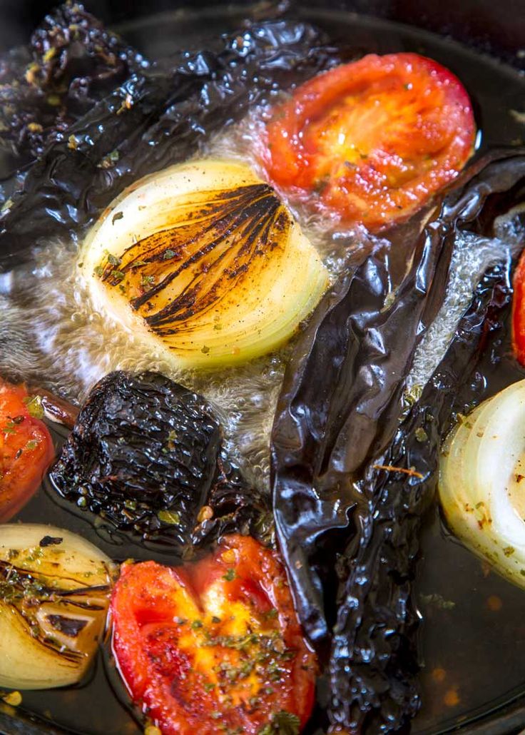 tomatoes and other vegetables are being cooked in oil