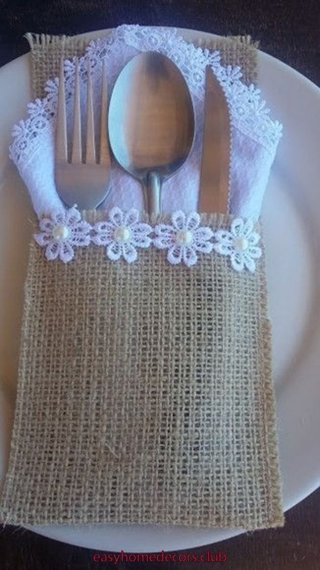 a white plate topped with a fork and knife next to a burlap napkin