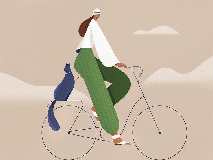 a woman riding a bike with a cat on the back