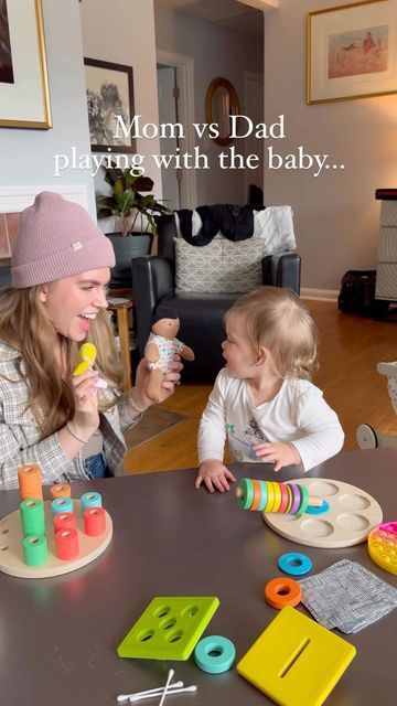 a woman playing with her baby at the table in front of them is an image that says mom vs dad playing with the baby