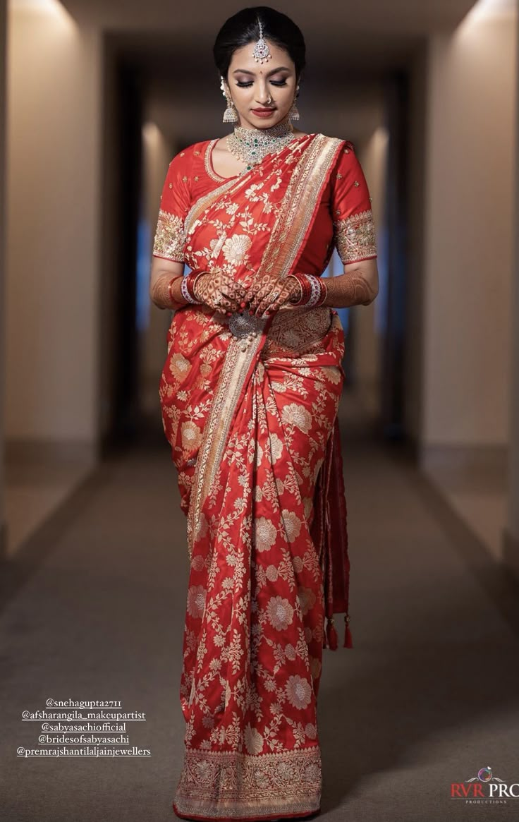 a woman in a red and gold sari