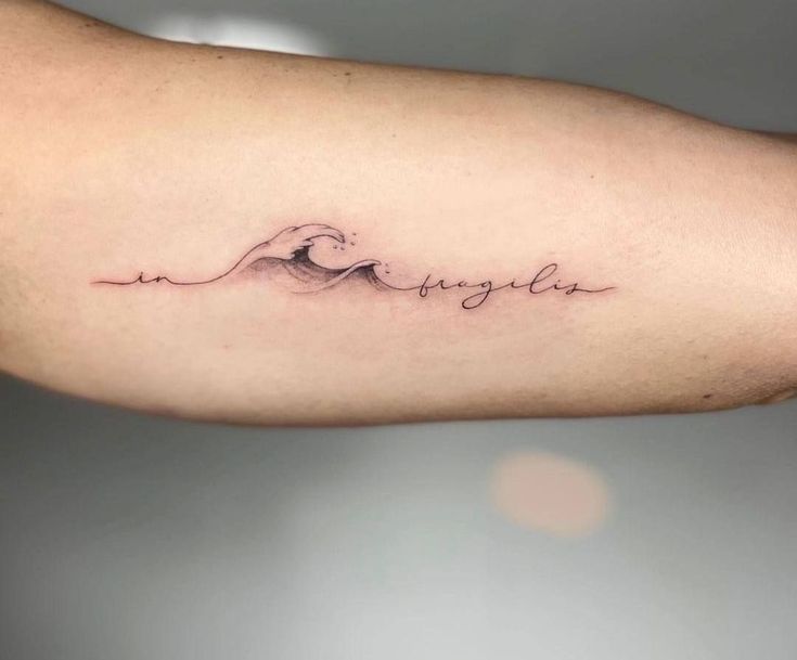 a person with a tattoo on their arm that says,'la laguna'in cursive writing