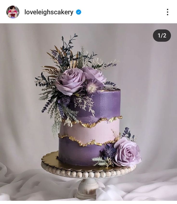 there is a purple cake with flowers on it