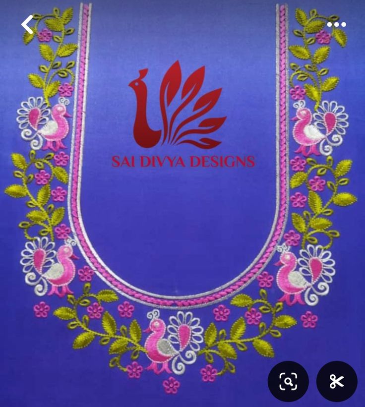 an applique on the back of a blue bag with pink flowers and leaves