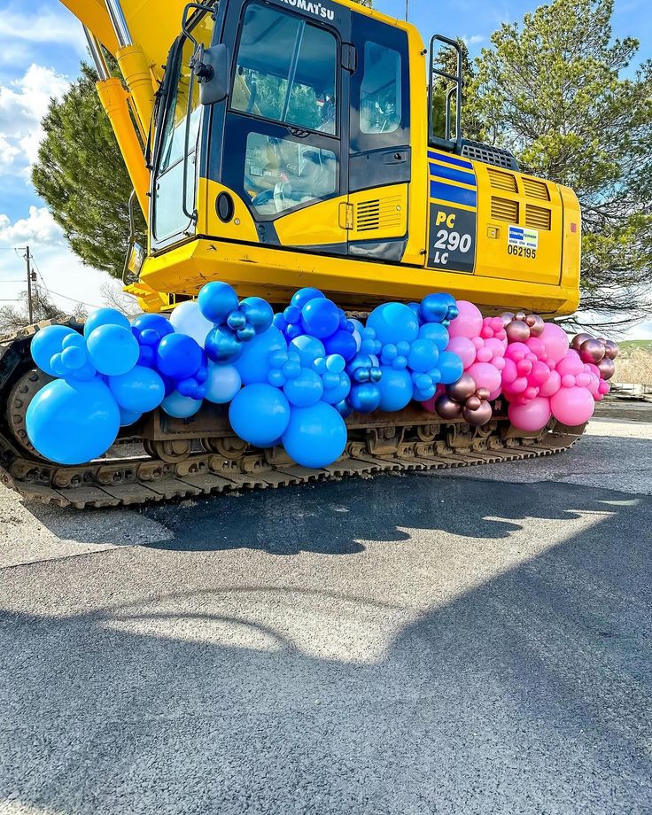 a tractor with balloons attached to it