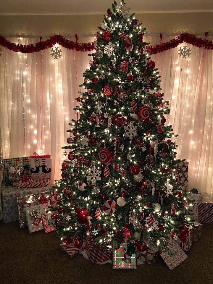 a decorated christmas tree with presents under it