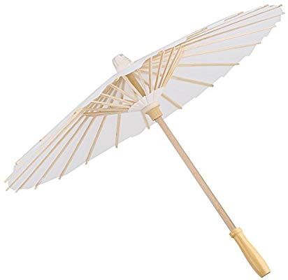 an umbrella that is white and has wooden sticks on the bottom of it, as well as a bamboo handle