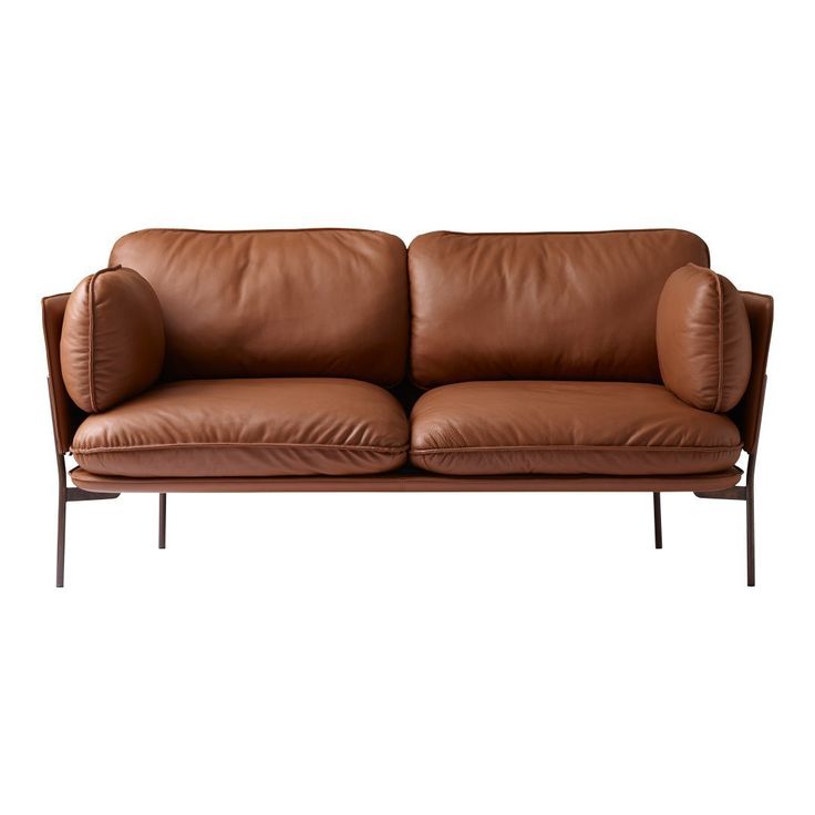 two brown leather couches sitting next to each other