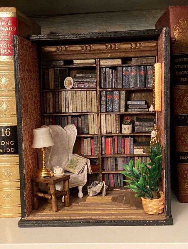 a miniature book shelf with books and a lamp