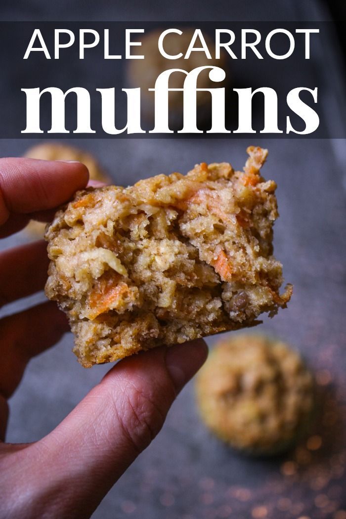 a hand holding an apple carrot muffins