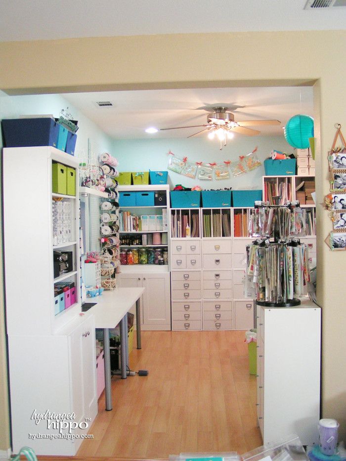 the inside of a craft room with lots of drawers and shelves filled with fabric items