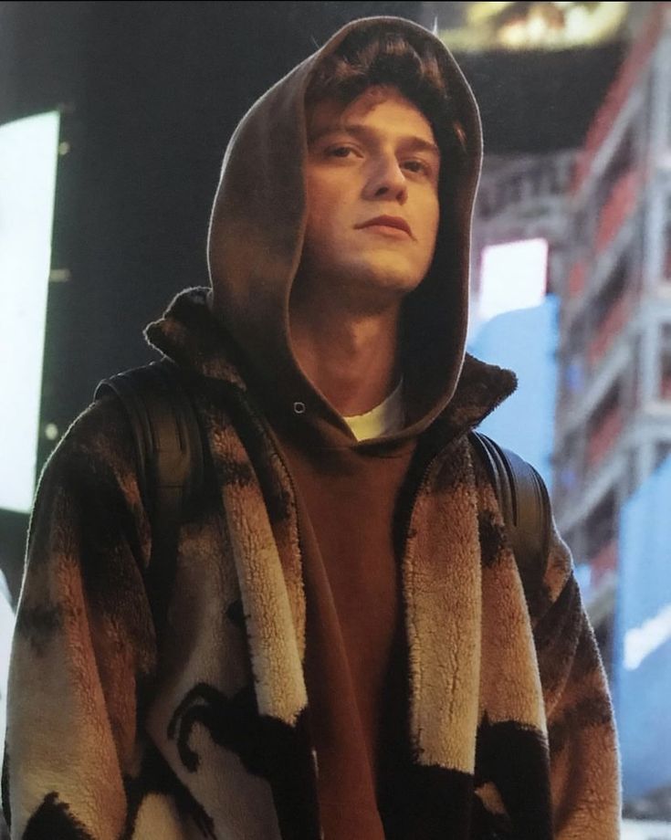 a young man wearing a hoodie in the city