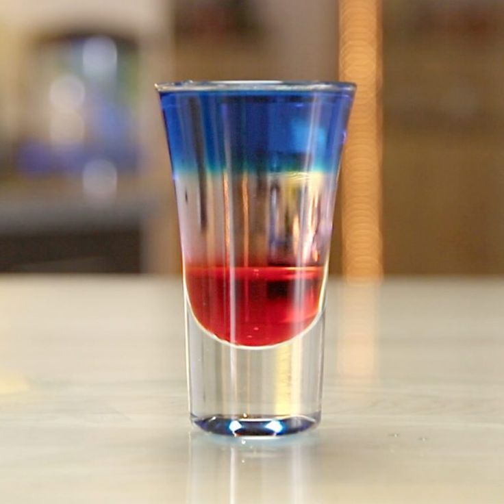 a shot glass filled with red and blue liquid