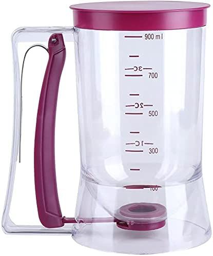 a pink blender with a measuring cup on the side and handle attached to it