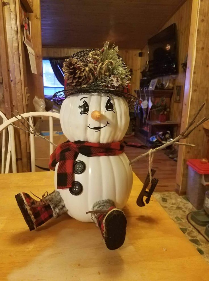 a snowman sitting on top of a wooden table