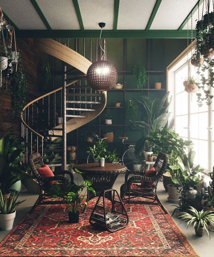 a room filled with lots of plants next to a spiral stair case in front of a window