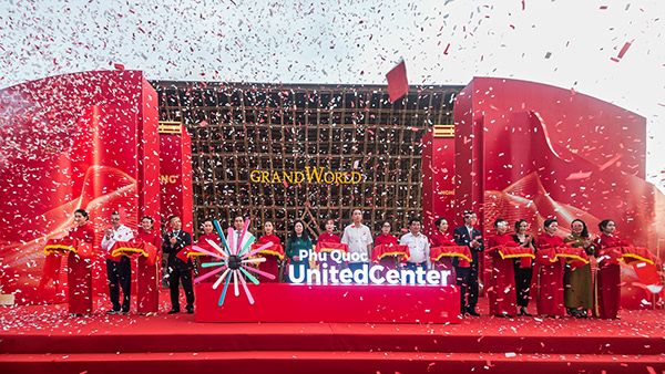 a group of people standing on top of a stage with confetti in the air