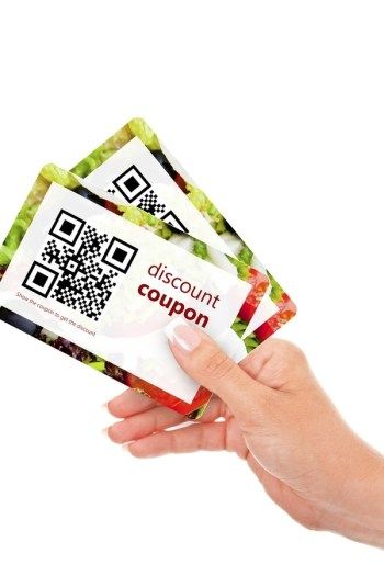 three coupons are being held up in the air by a person's hand