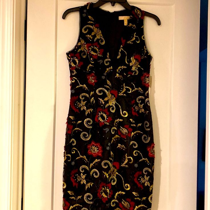 a black and red dress hanging on a white door