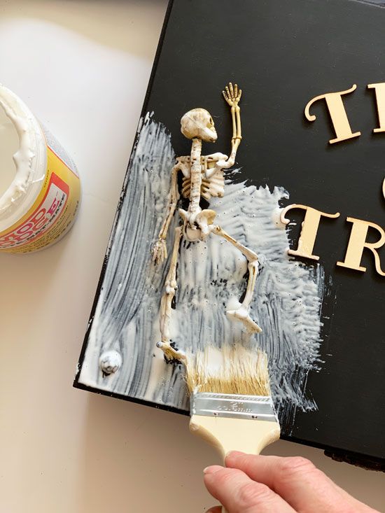 someone is painting a skeleton on a book