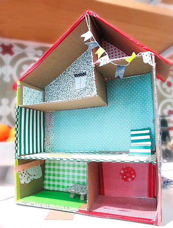 a doll house made out of cardboard sitting on top of a table