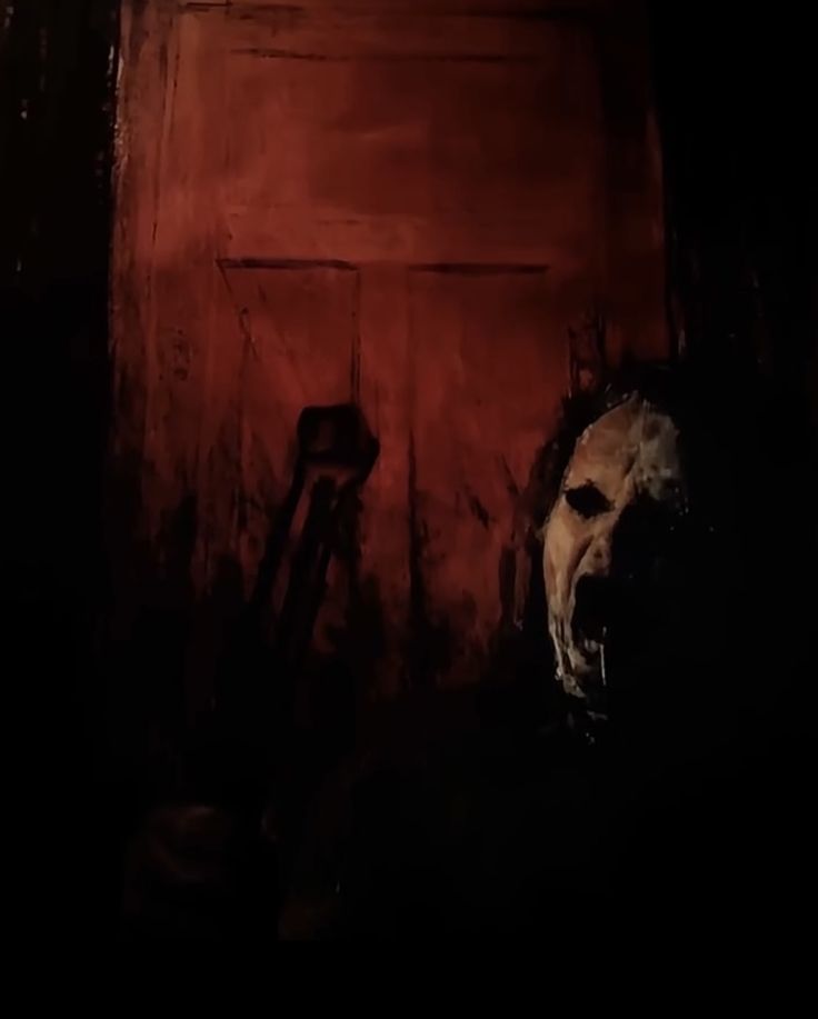 a creepy looking face in the dark with blood on it's walls and mouth