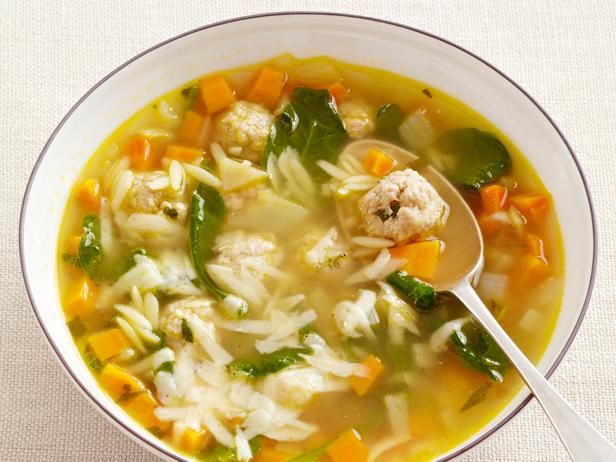 a white bowl filled with soup and vegetables