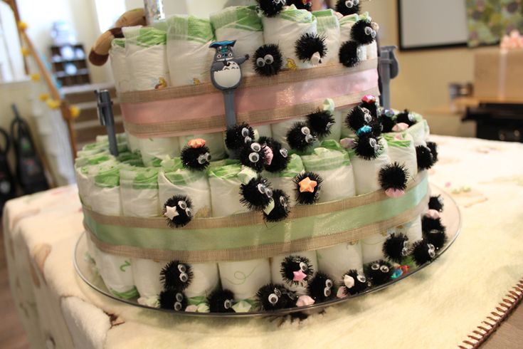 a diaper cake made to look like it is stacked high with black and white pom poms