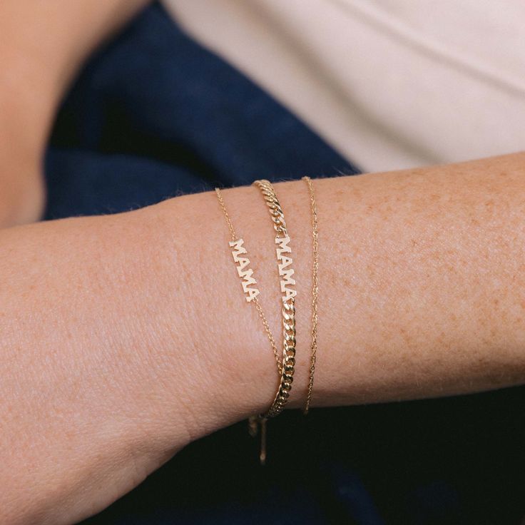 Celebrate love and motherhood with the charming Tiny Gold MAMA Bracelet. Available in 14K Yellow Gold Chain length = 6"-7" adjustable Letters = 3.5mm tall MAMA = 16mm across Dainty Nameplate Bracelets For Mother's Day, Personalized 14k Gold Adjustable Bracelets, Dainty 14k Gold Engraved Name Bracelet, Dainty 14k Gold Engraved Bracelets, Adjustable Name Bracelet As Gift For Mom, Dainty Engraved 14k Gold Name Bracelet, Adjustable Dainty 14k Gold Name Bracelet, Minimalist Yellow Gold Bracelets For Mother's Day, Adjustable 14k Gold Bracelet For Anniversary