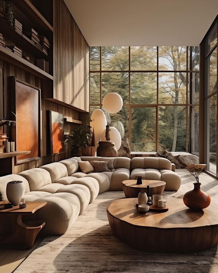 a modern living room with large windows and lots of furniture