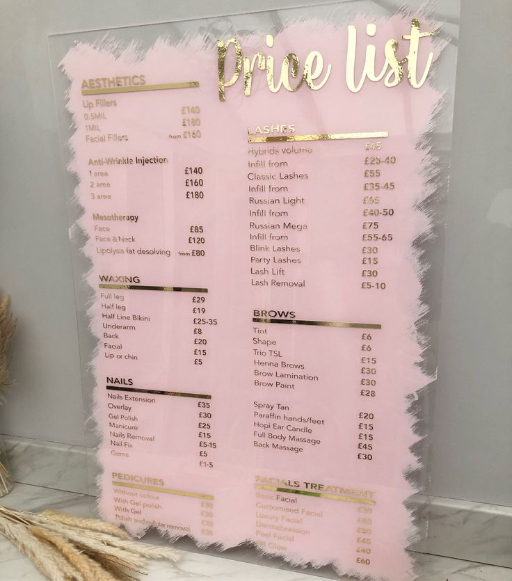 a pink price list with gold lettering on the front and bottom, next to some dried flowers