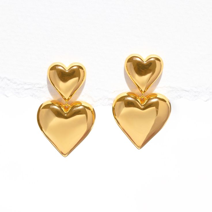 Give double the love with the Heartfelt Dangle Earrings! These bold beauties feature not one, but two hearts, adding a playful touch to your style. Whether you're off for a casual coffee date or a night out with friends, these earrings are your perfect match for a look that's as cute and fun as you are! Trendy Heart-shaped Drop Earrings For Anniversary, Trendy Heart Drop Earrings For Anniversary, Trendy Anniversary Heart Drop Earrings, Trendy Earrings For Anniversary And Mother's Day, Chic Heart Shaped Drop Earrings For Anniversary, Chic Heart Drop Earrings For Anniversary, Chic Anniversary Heart Drop Earrings, Trendy Double Heart Earrings For Valentine's Day, Trendy Heart Earrings For Valentine's Day Anniversary