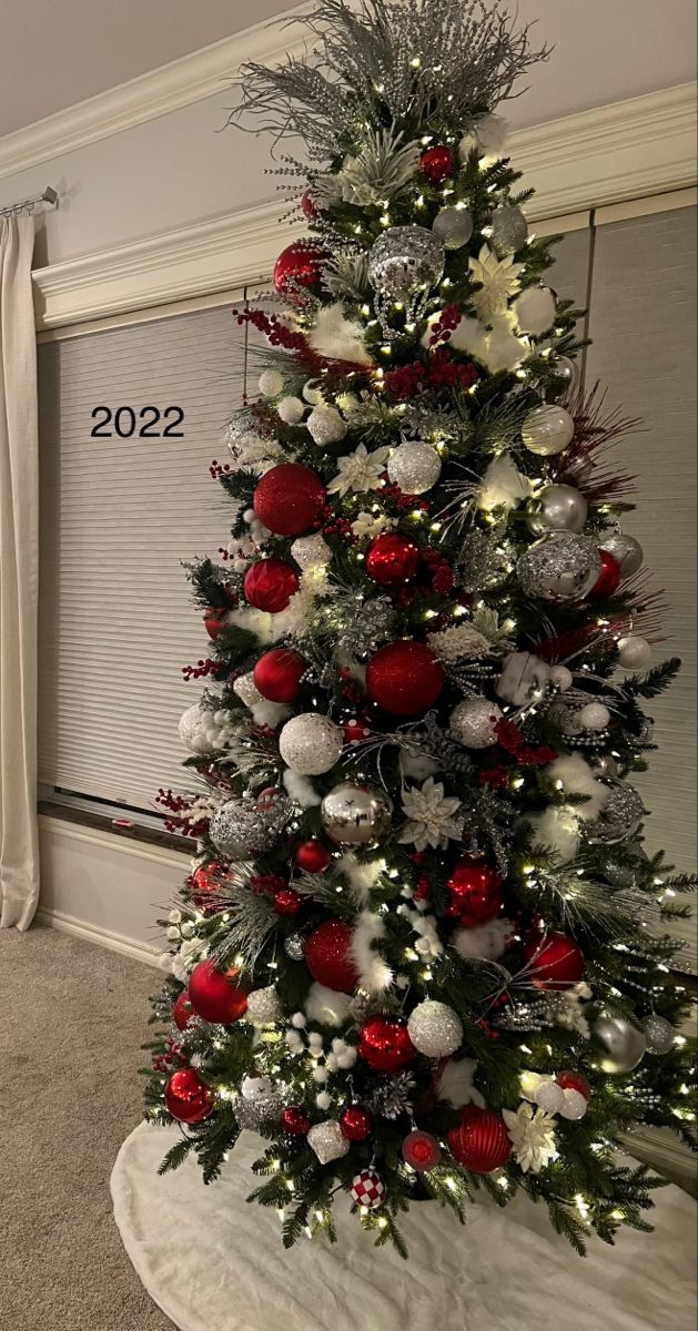 a christmas tree decorated with red and silver ornaments