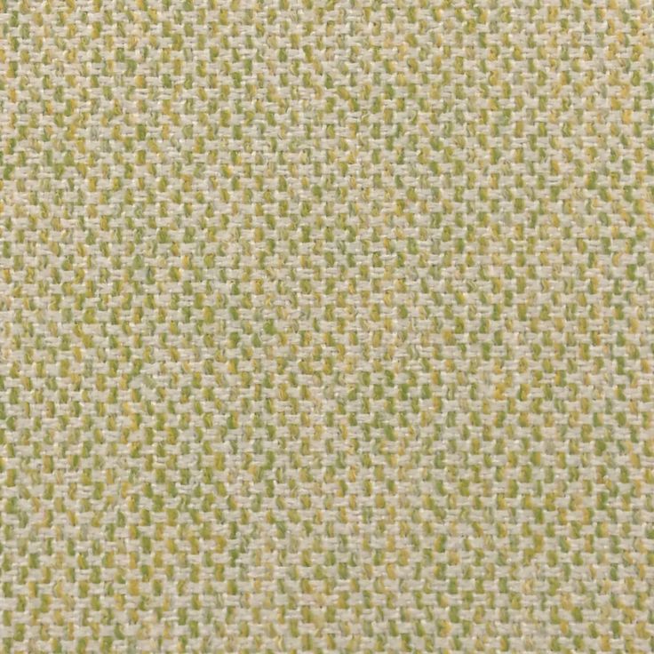 an upholstered green and white fabric textured with small dots on the surface