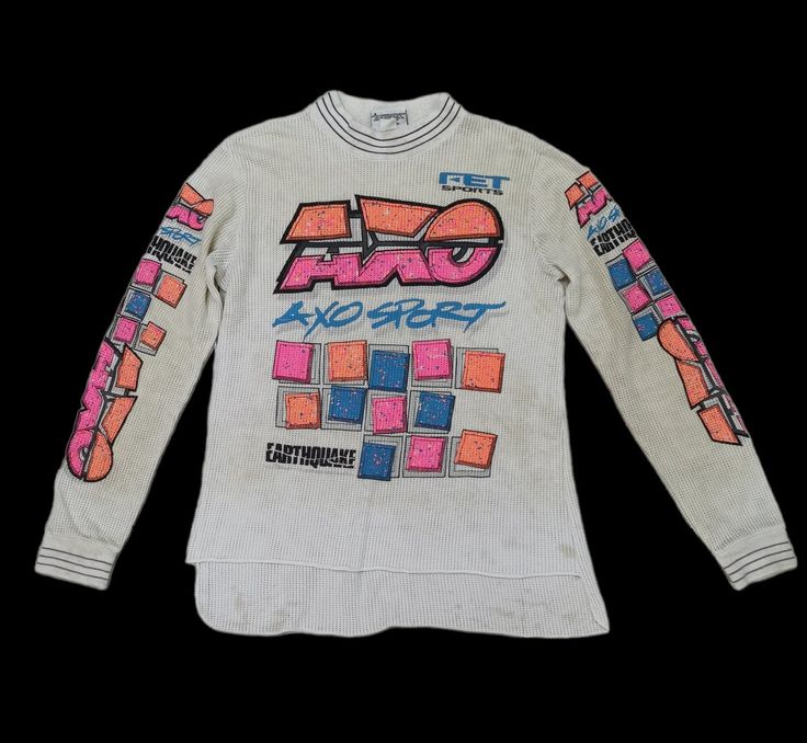 Please read all description carefully before buying. If you have any questions feel free to ask. Vintage clothing fits differently from modern day clothing. Please don't just rely on tag size, make sure to check all the measurements given below for an accurate size. PLEASE CHECK ACTUAL SIZE CAREFULLY, NO RETURNS OR COMPLAINT FOR WRONG SIZE ACTUAL. Vintage 1990 Axo Earthquake Motocross Jersey with Signature  Colour : Multicolour  Size on tag : -  Brand : Axo Condition : Good condition. Yellowish.  MEASUREMENT Armpit to armpit : 19" Length : 27" ACCEPT PAYPAL ONLY.  Shipping cost is $18 for economy or $28 DHL Express wordwide shipping. Transit time can take  2-3 weeks for economy and 3-5 business days by DHL Express to reach destination.  Please leave your phone number on the note while make 90s Style Long Sleeve Graphic Print Shirt, 90s Style Long Sleeve Shirt With Graphic Print, Retro Long Sleeve Shirt For Streetwear, 90s Long Sleeve Shirt With Graphic Print, 90s Style Long Sleeve Shirt For Streetwear, 90s Long Sleeve Shirt For Streetwear, Retro Long Sleeve Tops With Graphic Design, Vintage Long Sleeve Tops With Graphic Design, Vintage Long Sleeve Graphic Tops