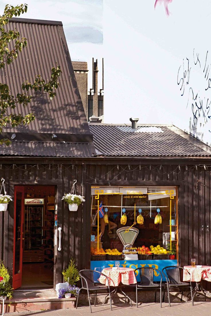 a small store with tables and chairs outside