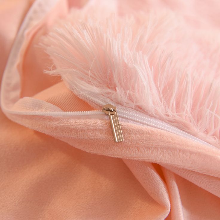 the zipper is open and there is a pink feather on it's back side