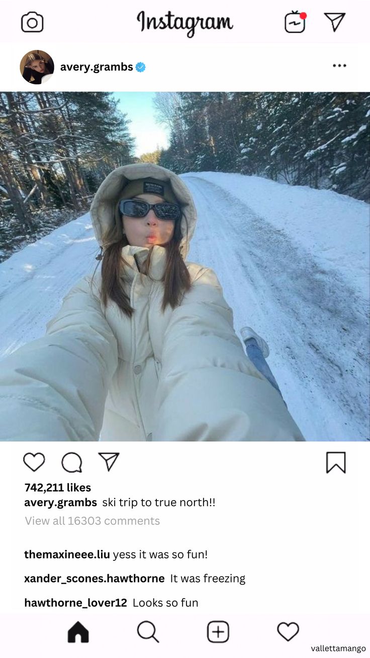 a woman taking a selfie on her instagram with snow and trees in the background