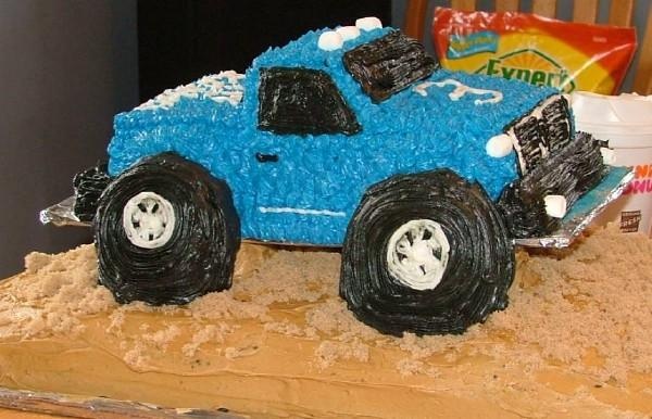 a cake shaped like a monster truck on top of a table