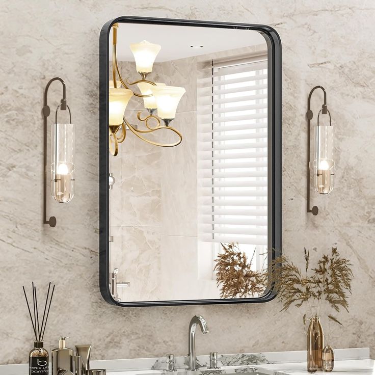 a bathroom sink sitting under a mirror next to a wall mounted faucet with lights on it