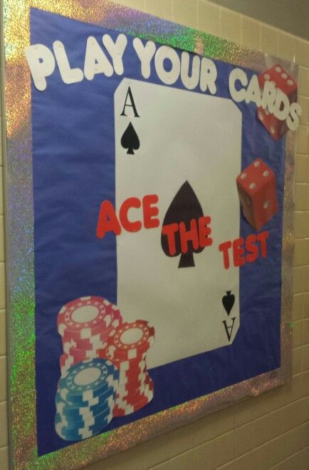 a bulletin board with cards and dices on it that says play your cards ace the test