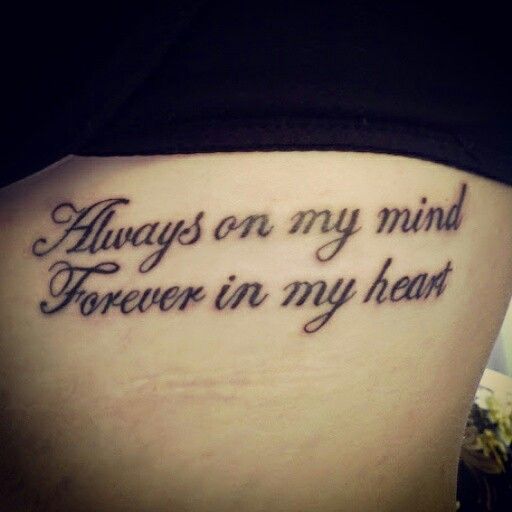 a woman's lower back tattoo with the words always on my mind, forever in my heart