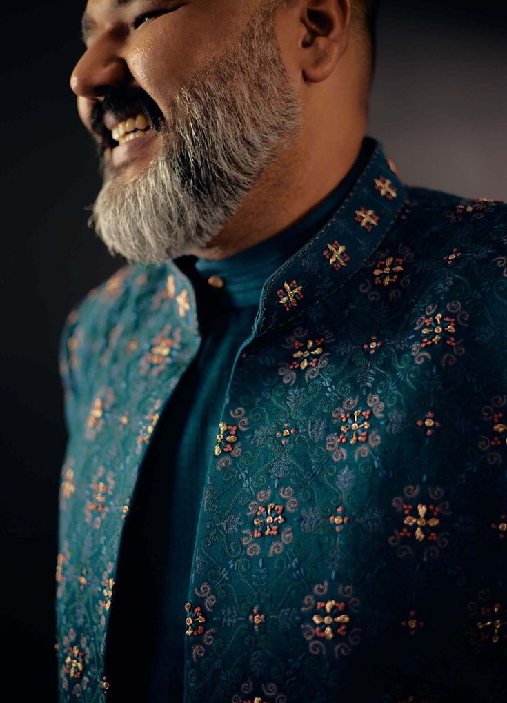 Editor's Note Featuring Floral Jamawar Embroidered Teal Green Open Sherwani Set With Dabka Highlighting. Paired With Matching Angrakha Kurta And Tapered Trousers. Fabric: Linen Silk Color: Teal Green Component: Sherwani, Kurta, Trousers Care: Dry Clean Only About the Designer After establishing himself as the leading couturier in the industry of menswear, Jatin Malik went on to explore luxury footwear. You can order online these amazingly designed handmade shoes that are being offered in classy Festive Green Anarkali Sherwani, Green Anarkali Sherwani For Festivals, Green Anarkali Style Sherwani With Traditional Drape, Green Sherwani With Dabka For Eid, Green Sherwani With Embroidery For Eid, Green Dabka Sherwani For Eid, Green Bollywood Bandhgala With Dabka Detail, Green Bollywood Bandhgala With Dabka, Anarkali Nehru Jacket With Dabka For Diwali